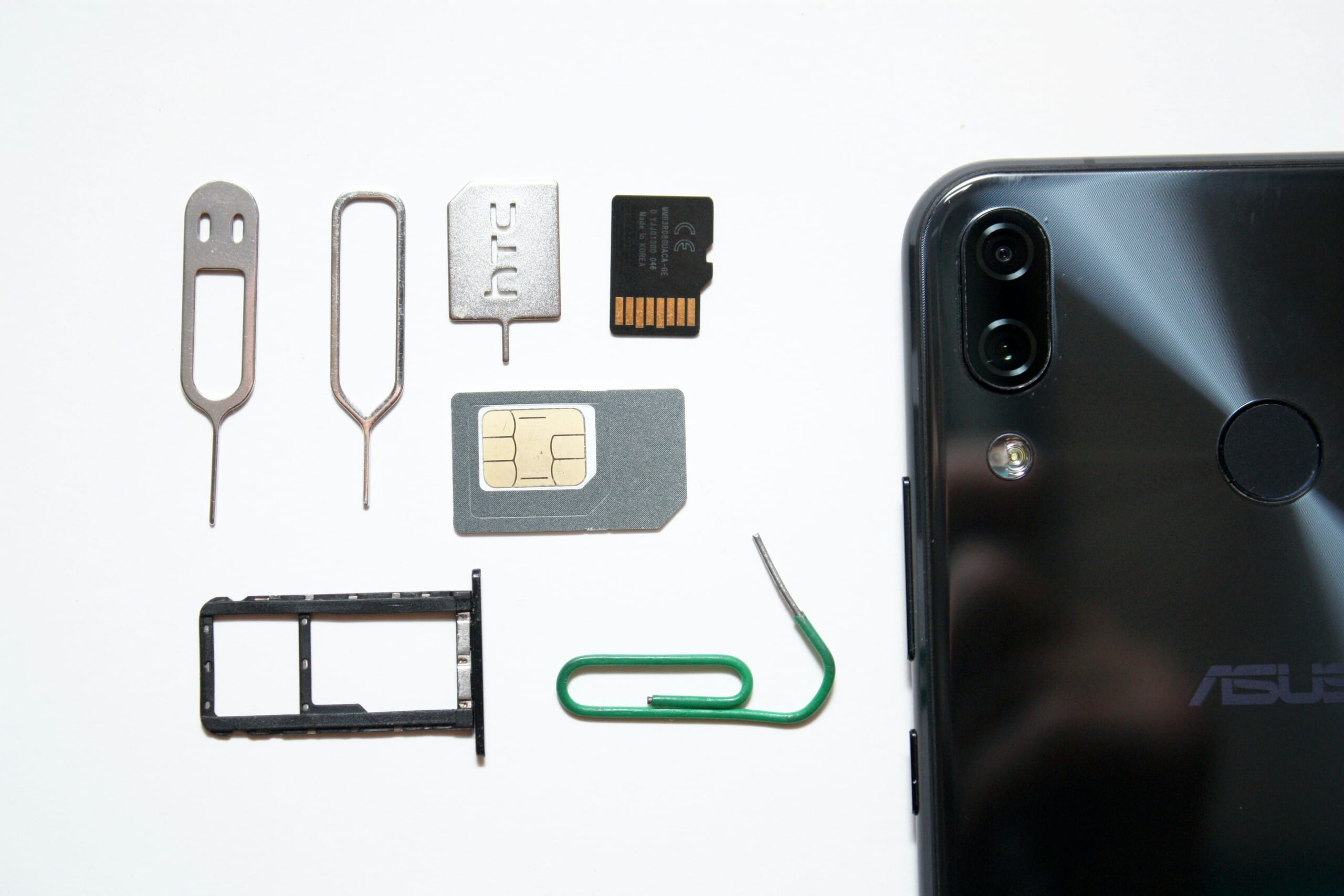 A smartphone SIM tray, physical SIM card and SIM eject tool