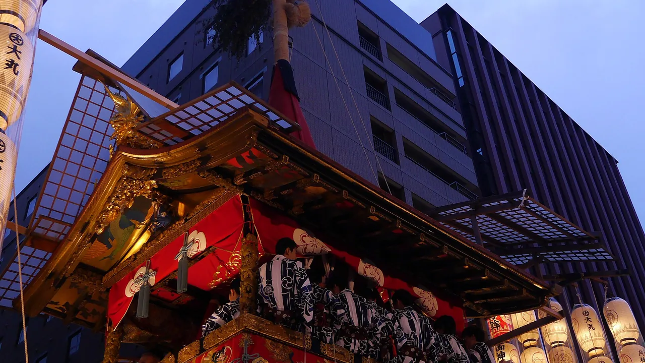 A Gion Matsuri float illuminated by lanterns at night