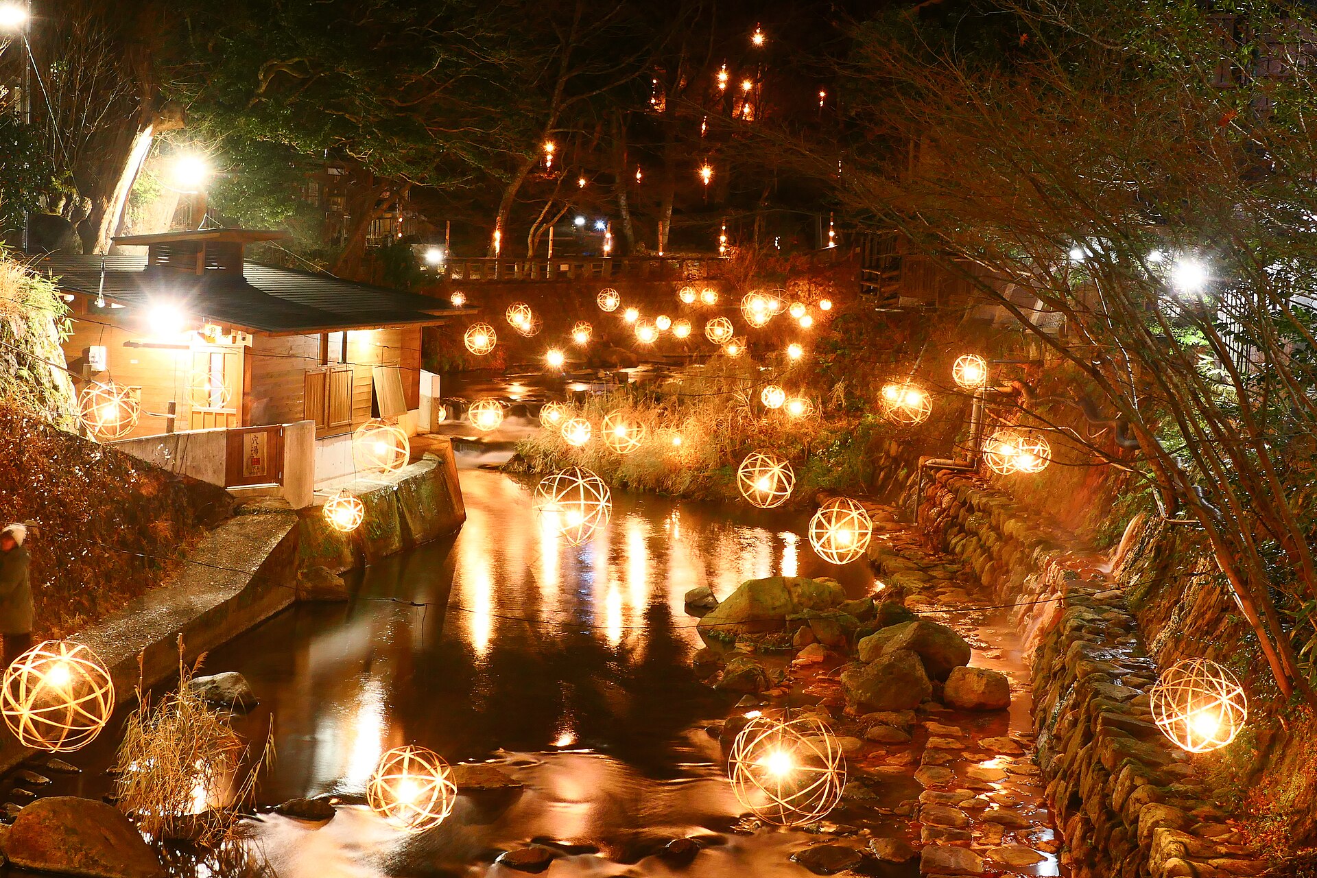 Illuminated ball lanterns above the Tanoharu River in Kurokawa Onsen in winter