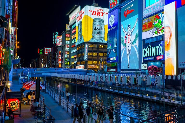 Restaurant neon reflected in the Dotonbori River at night