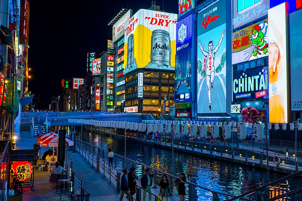Restaurant neon reflected in the Dotonbori River at night