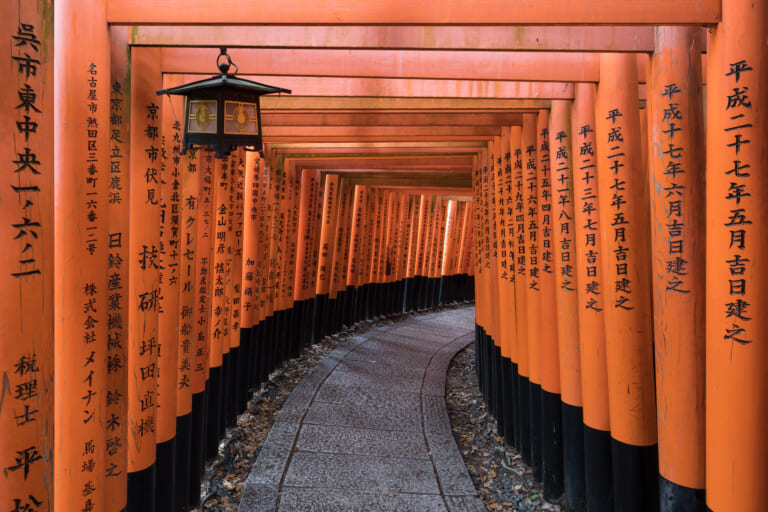 Vermilion torii gates and a lantern at Fushimi Inari Taisha