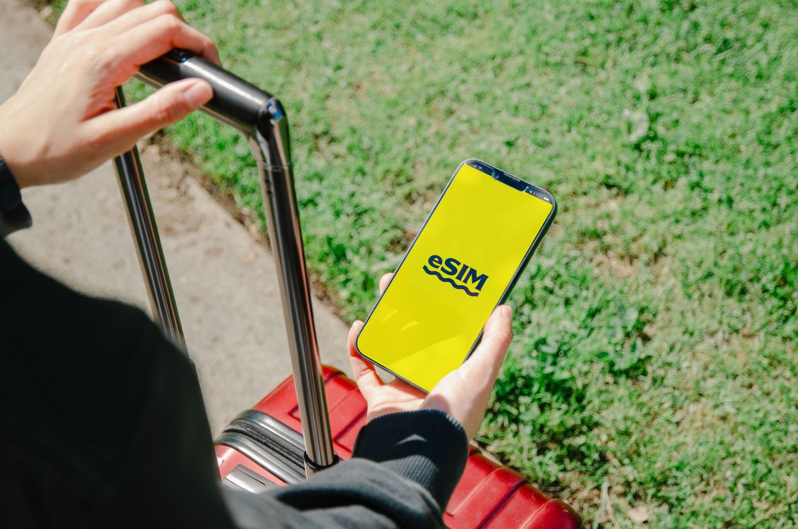 Traveler checking an eSIM on a smartphone