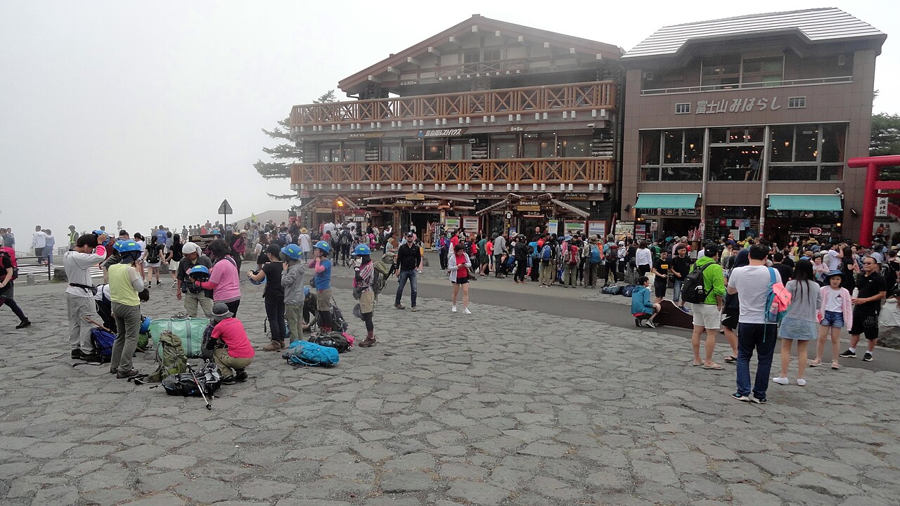 Visitors in the plaza at Fuji Subaru Line Fifth Station in low cloud
