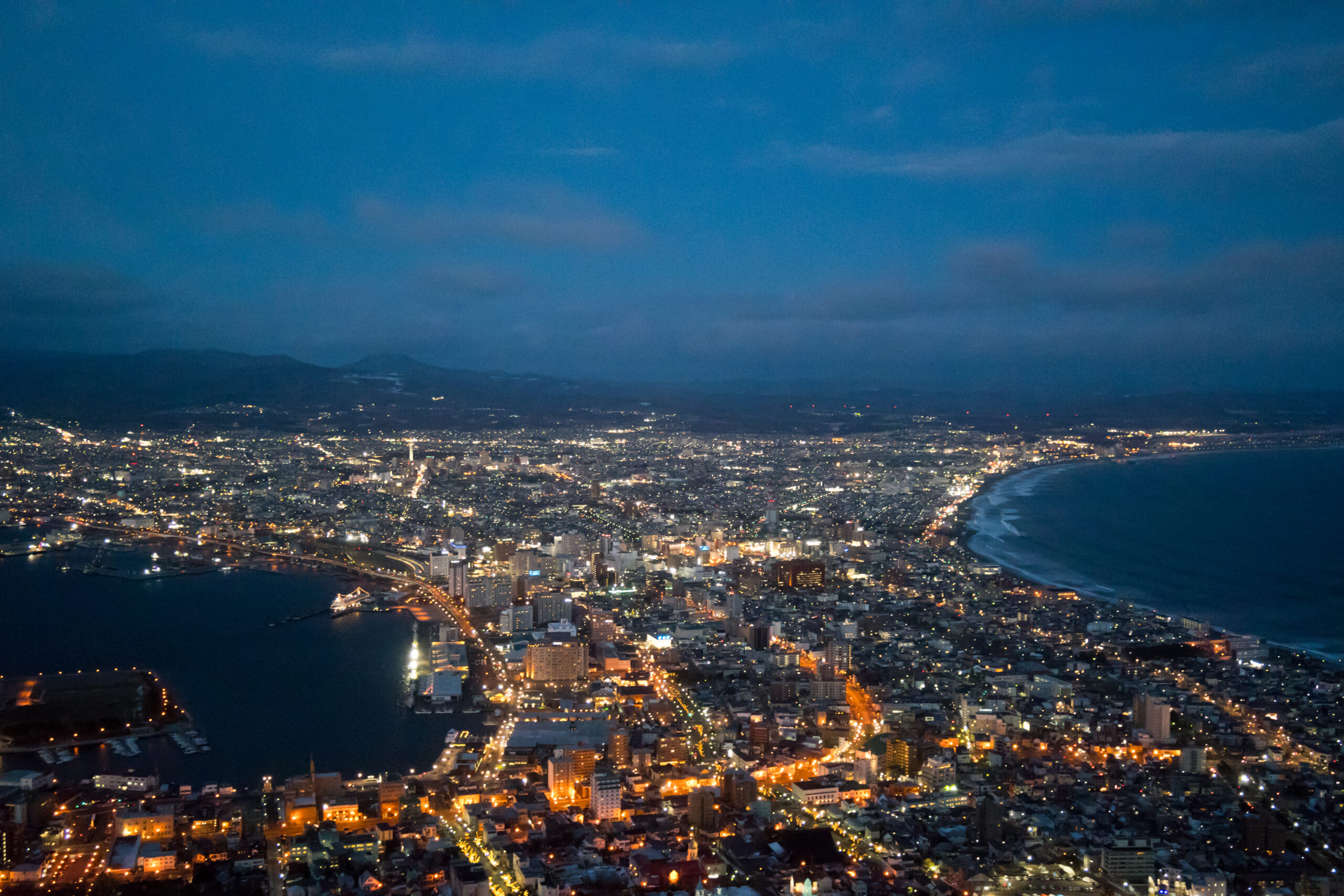 Hakodate city lights between two bays at dusk, viewed from Mount Hakodate