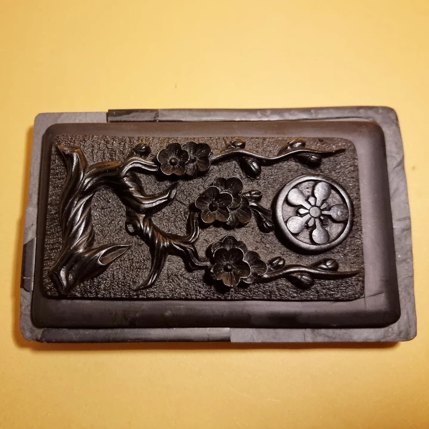 Japanese inkstone carved with plum blossoms, a reference photograph
