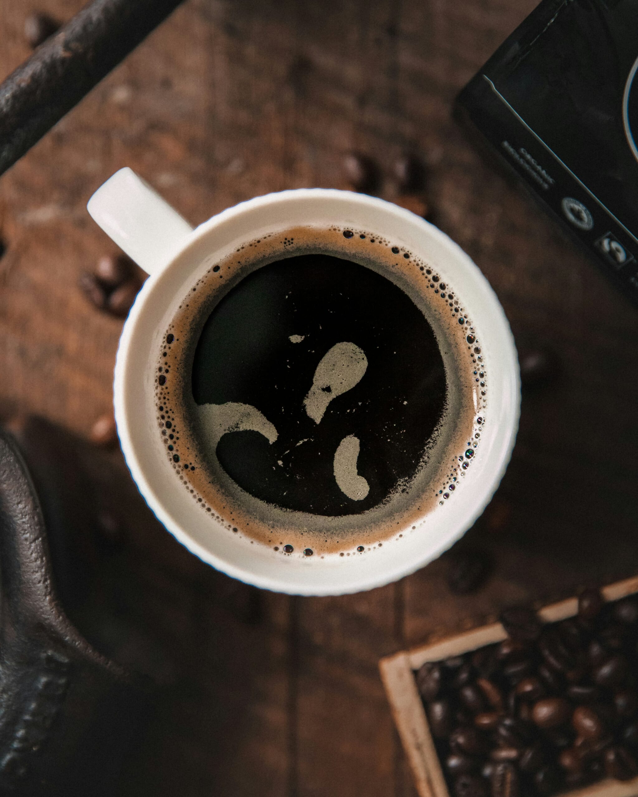 An illustrative photo of black coffee in a white cup