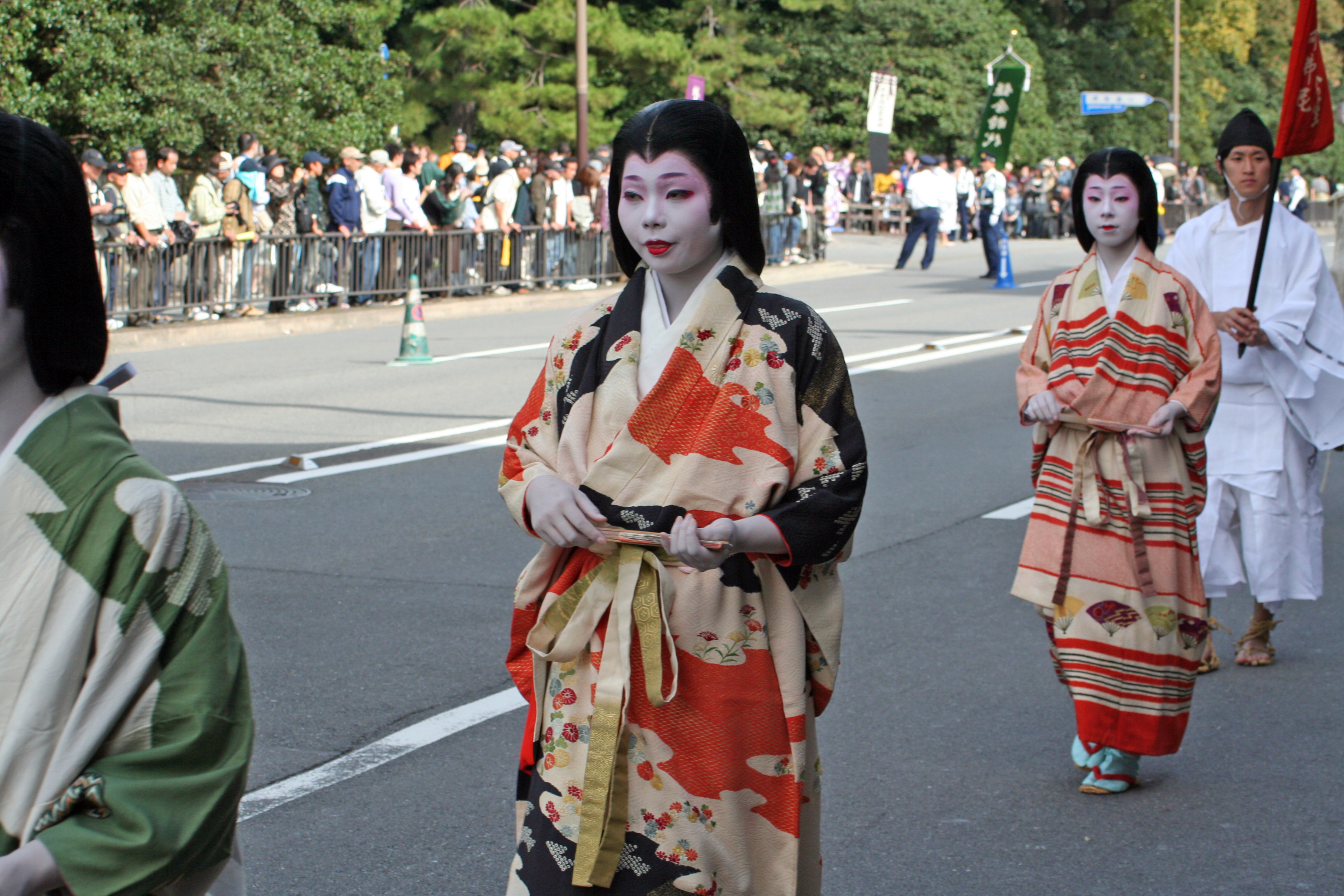 Kimono-clad participants passing spectators along the Jidai Matsuri parade route