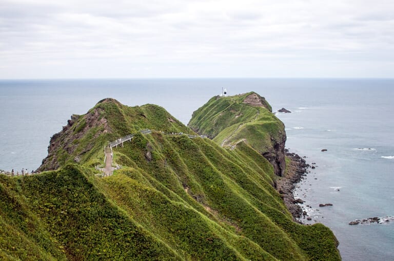 Cape Kamui extending into the sea beneath green ridges