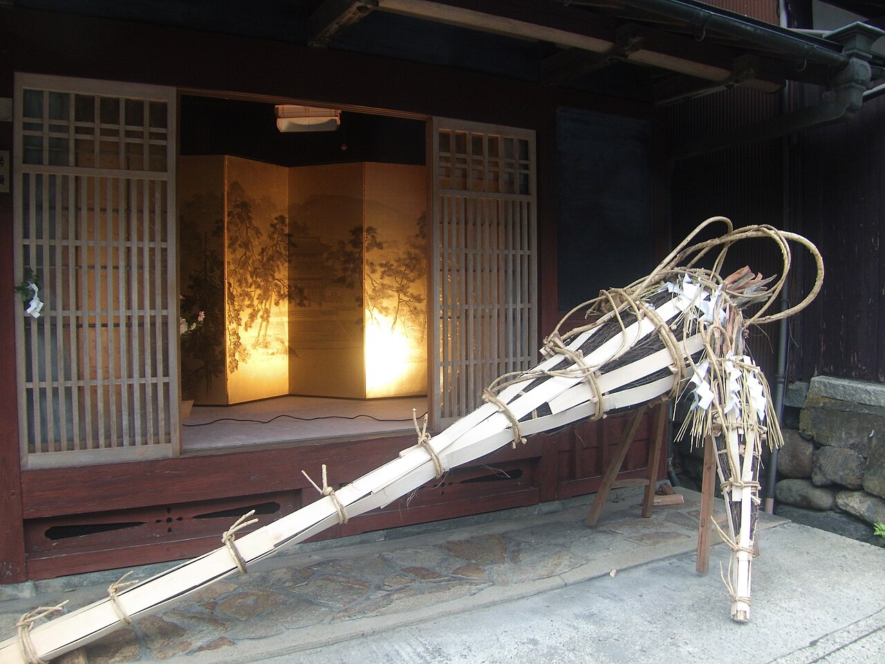 Festival torches standing outside a wooden house in Kurama