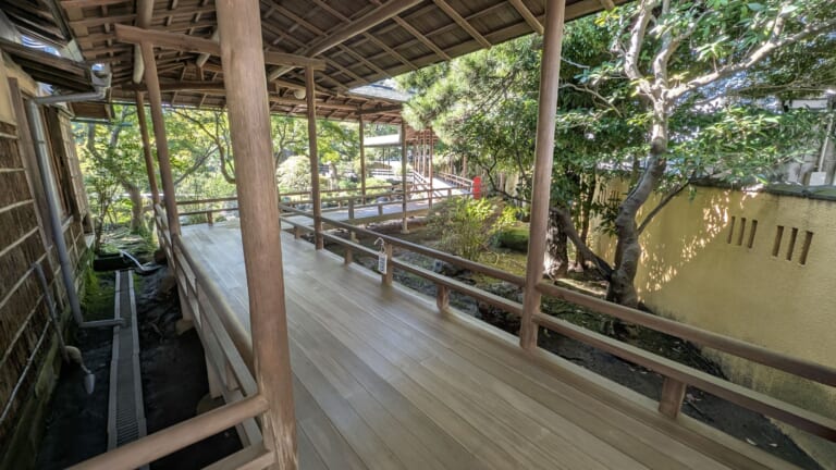 A roofed wooden corridor overlooking the garden at Shibamata Taishakuten