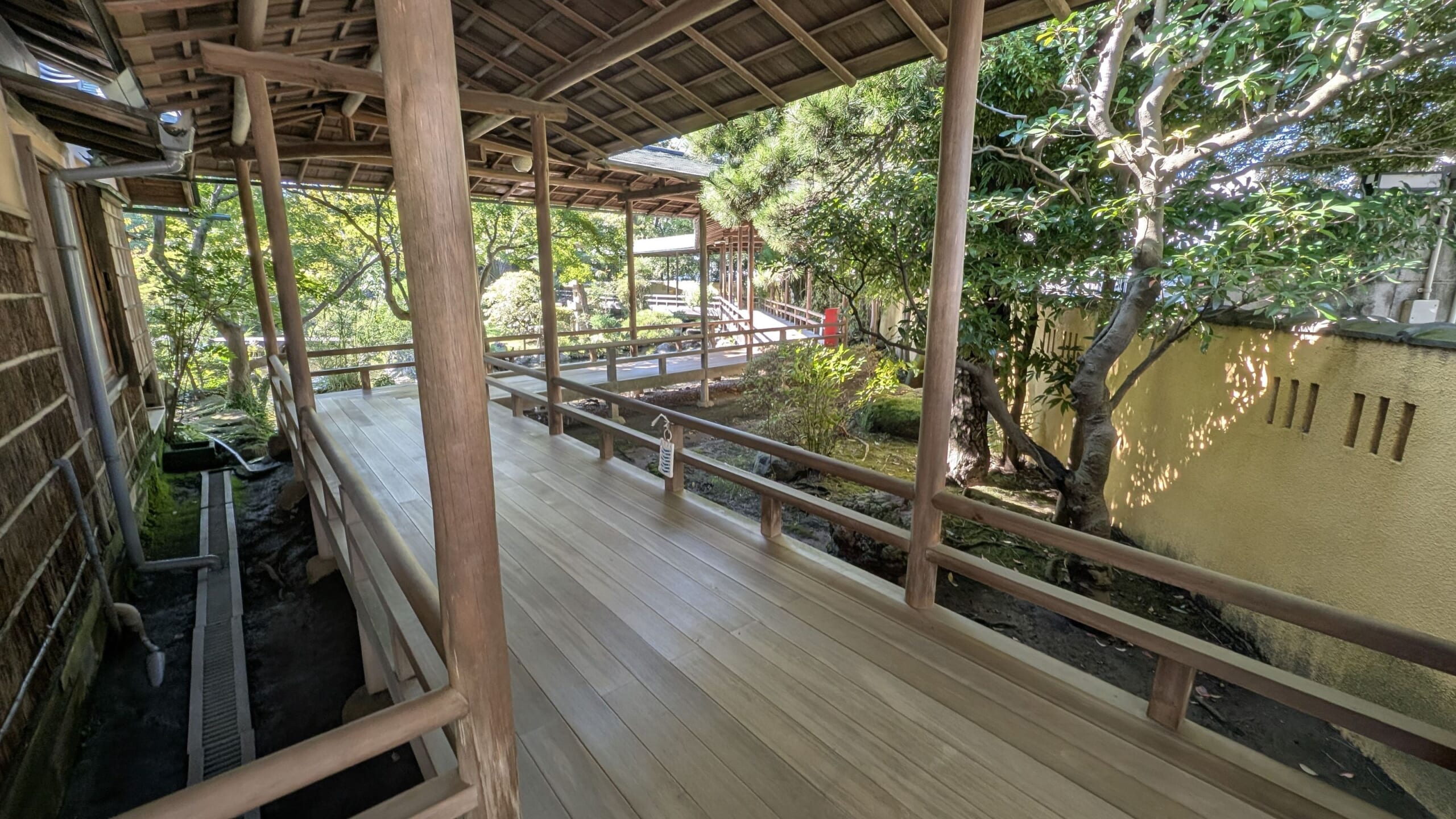 A roofed wooden corridor overlooking the garden at Shibamata Taishakuten