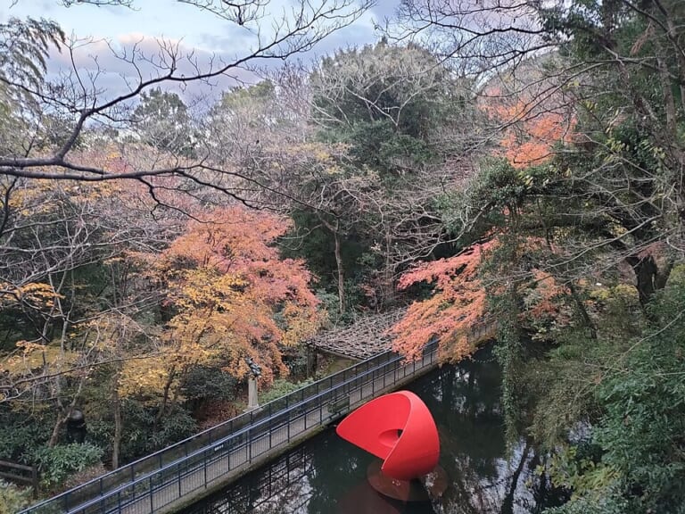 An exhibit among autumn leaves at the Hakone Open-Air Museum
