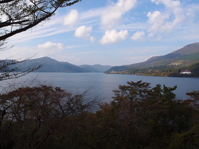 Lake Ashi framed by trees at Onshi-Hakone Park
