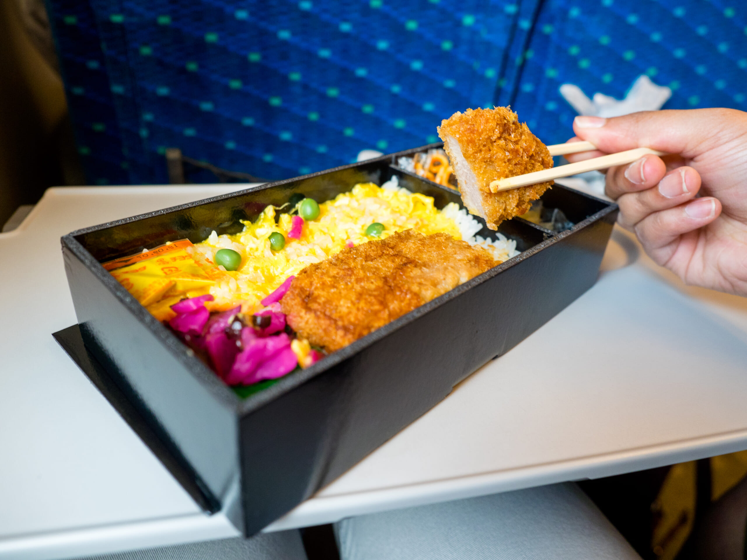 A chicken ekiben on a Shinkansen seat table