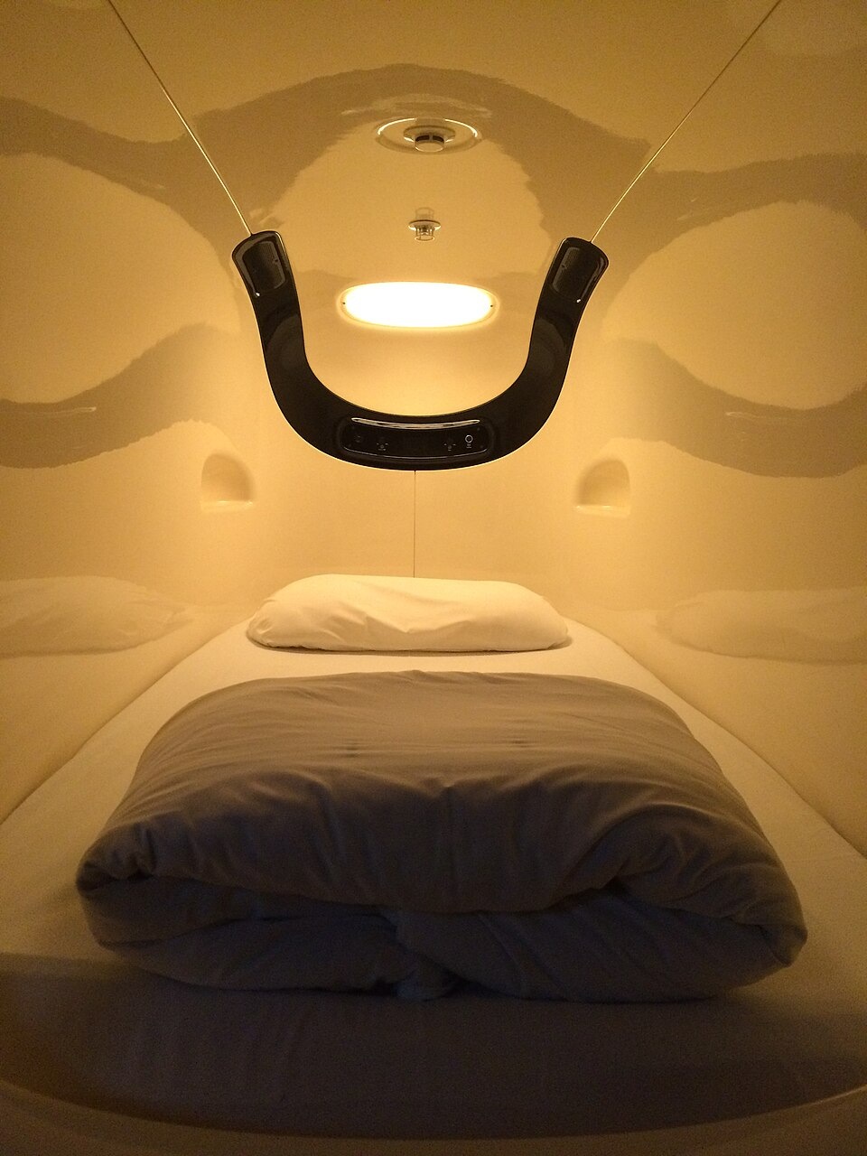 Bedding and lighting inside a sleeping pod