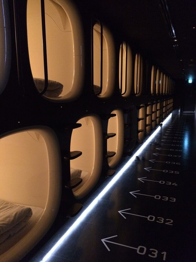 A row of sleeping-pod entrances at a capsule hotel in Narita Airport