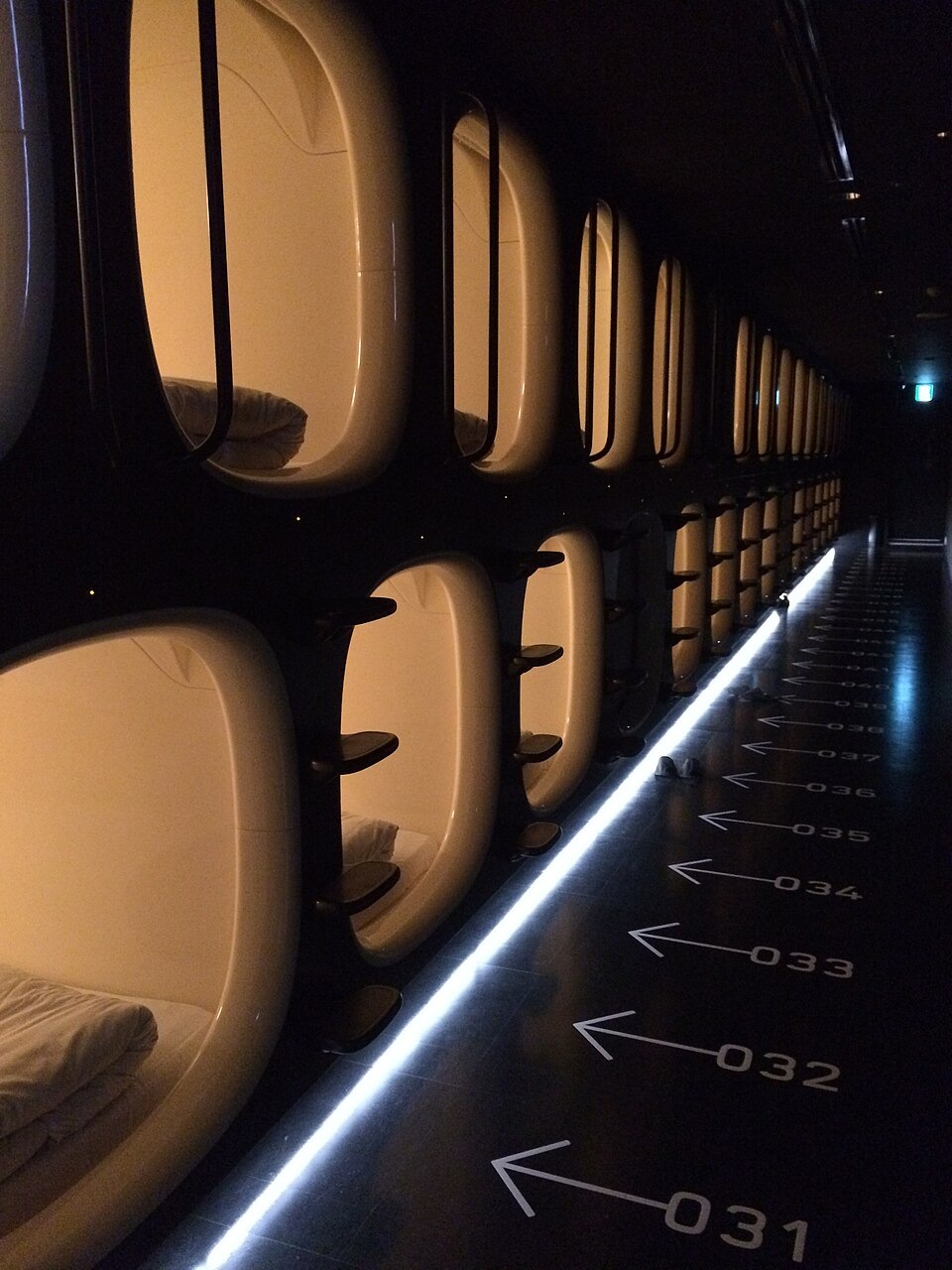 A row of sleeping-pod entrances at a capsule hotel in Narita Airport