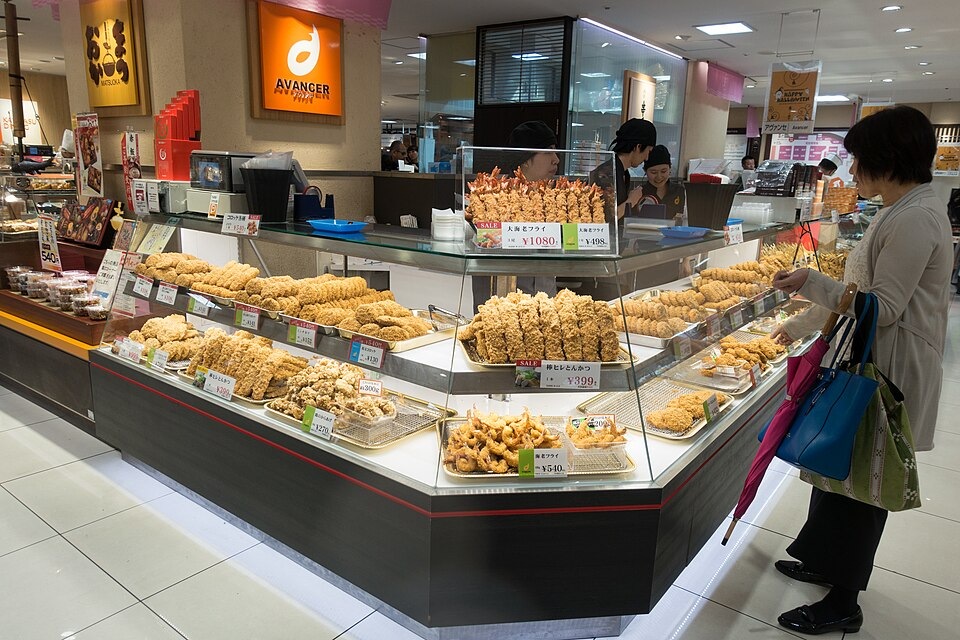 Fried-food counters and shoppers at a Takashimaya food hall