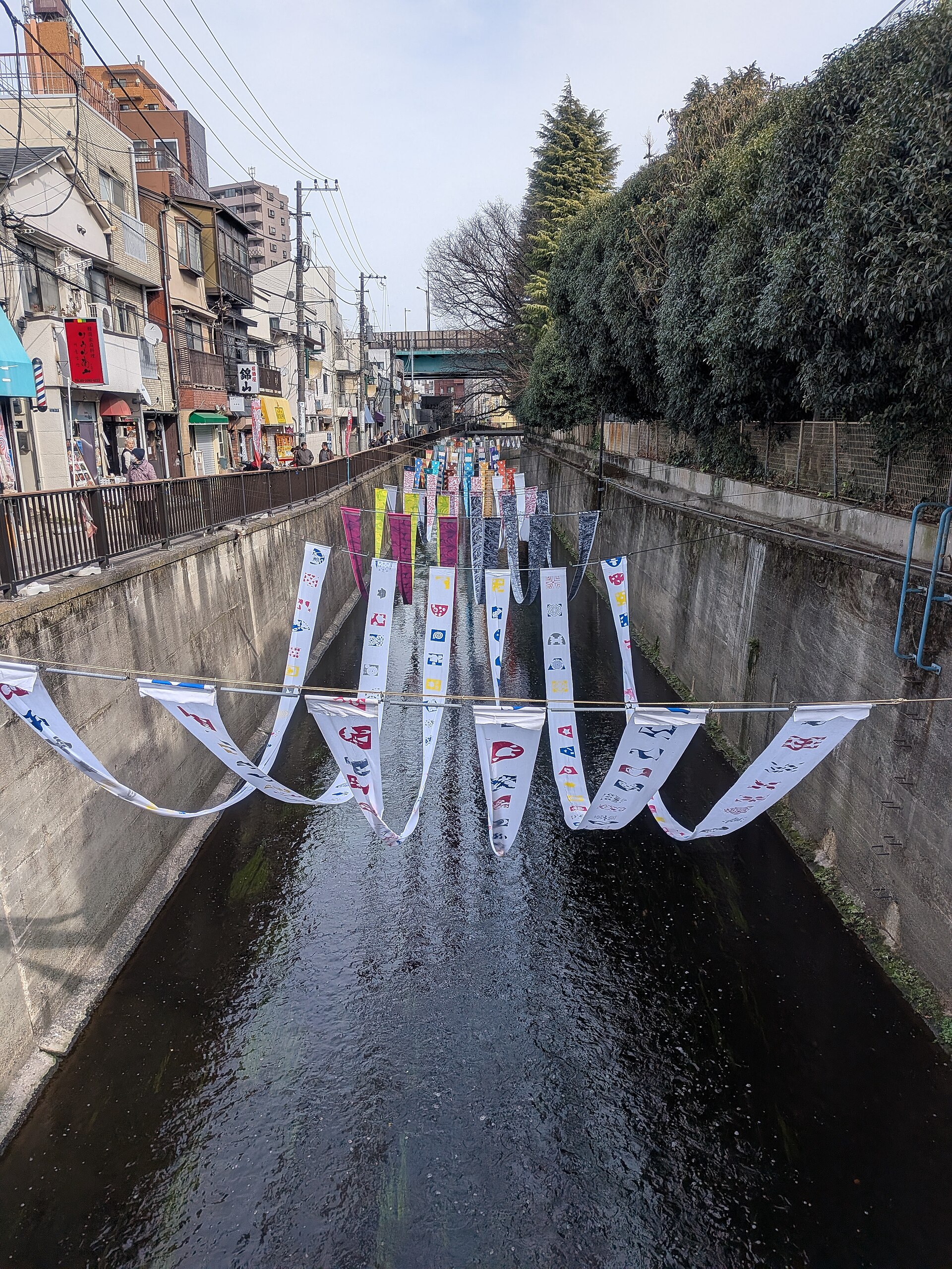 Dyed textiles displayed above the Myoshoji River during Some no Komichi in 2026