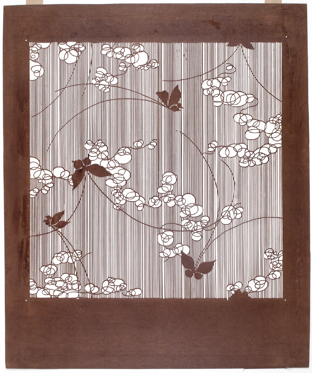 A displayed Japanese dyeing stencil with flower and bird patterns