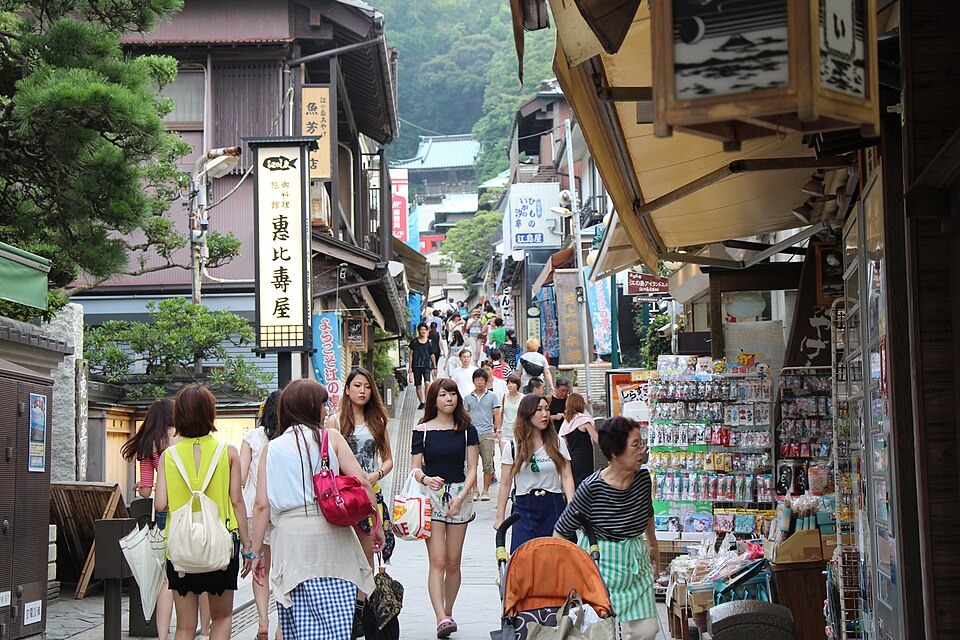 Shops and visitors along an uphill street on Enoshima