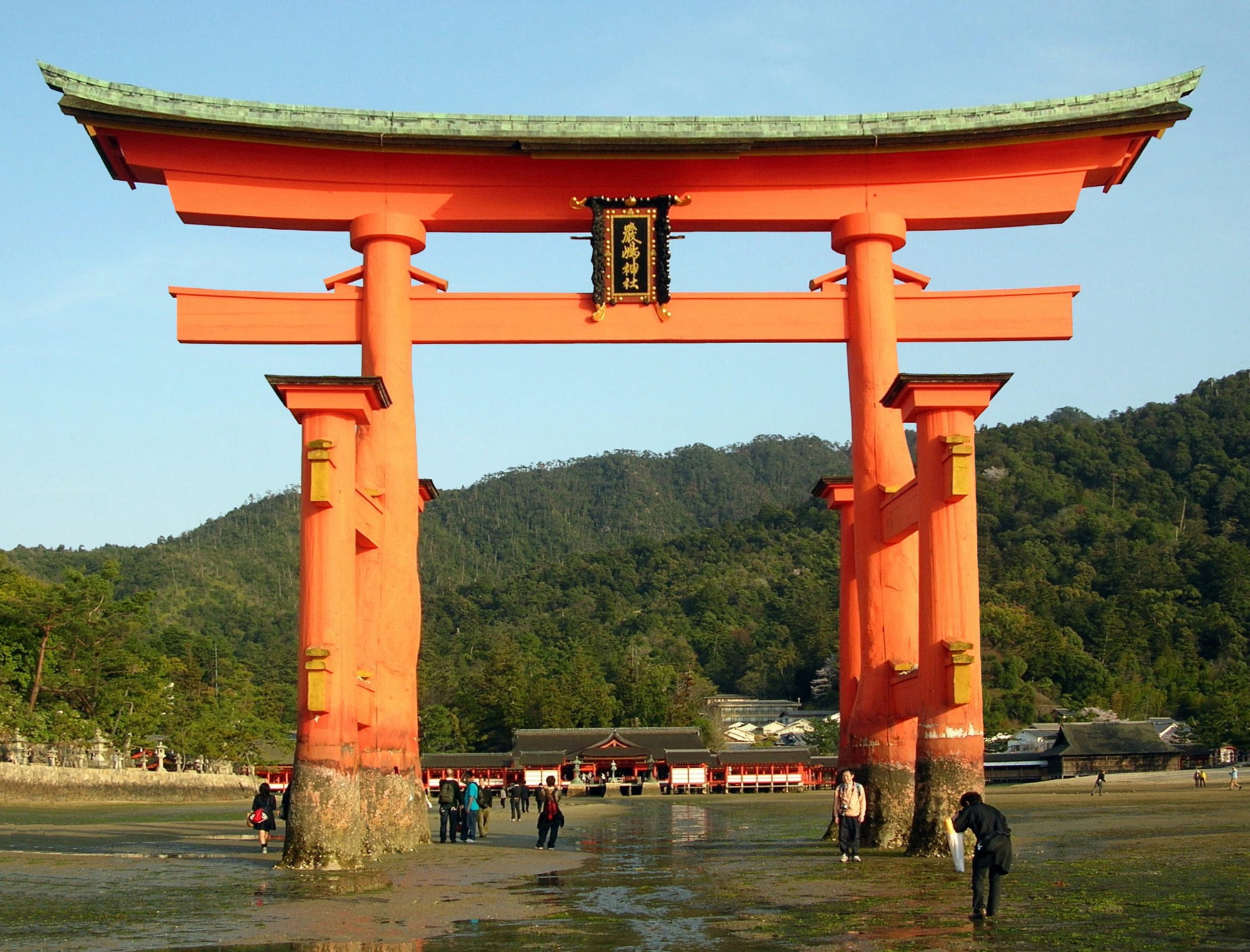 The Great Torii at Itsukushima Shrine with exposed shore and the shrine behind it